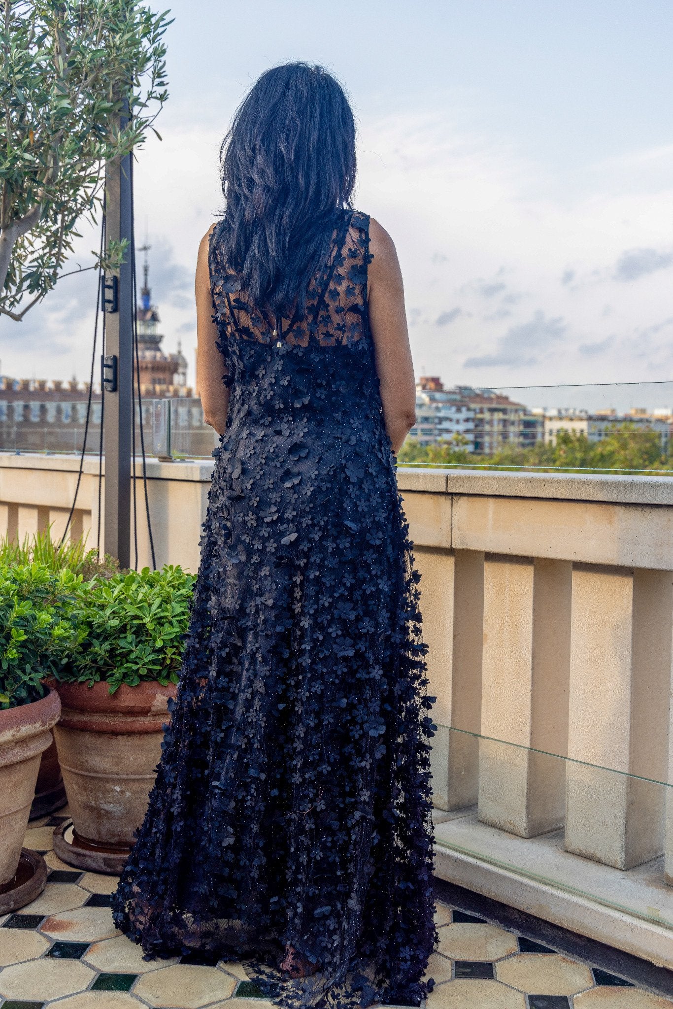 Daisy Noir by Preema Aura worn over a black satin slip, emphasising the intricate 3D floral embellishment and dramatic sheer texture from the back.