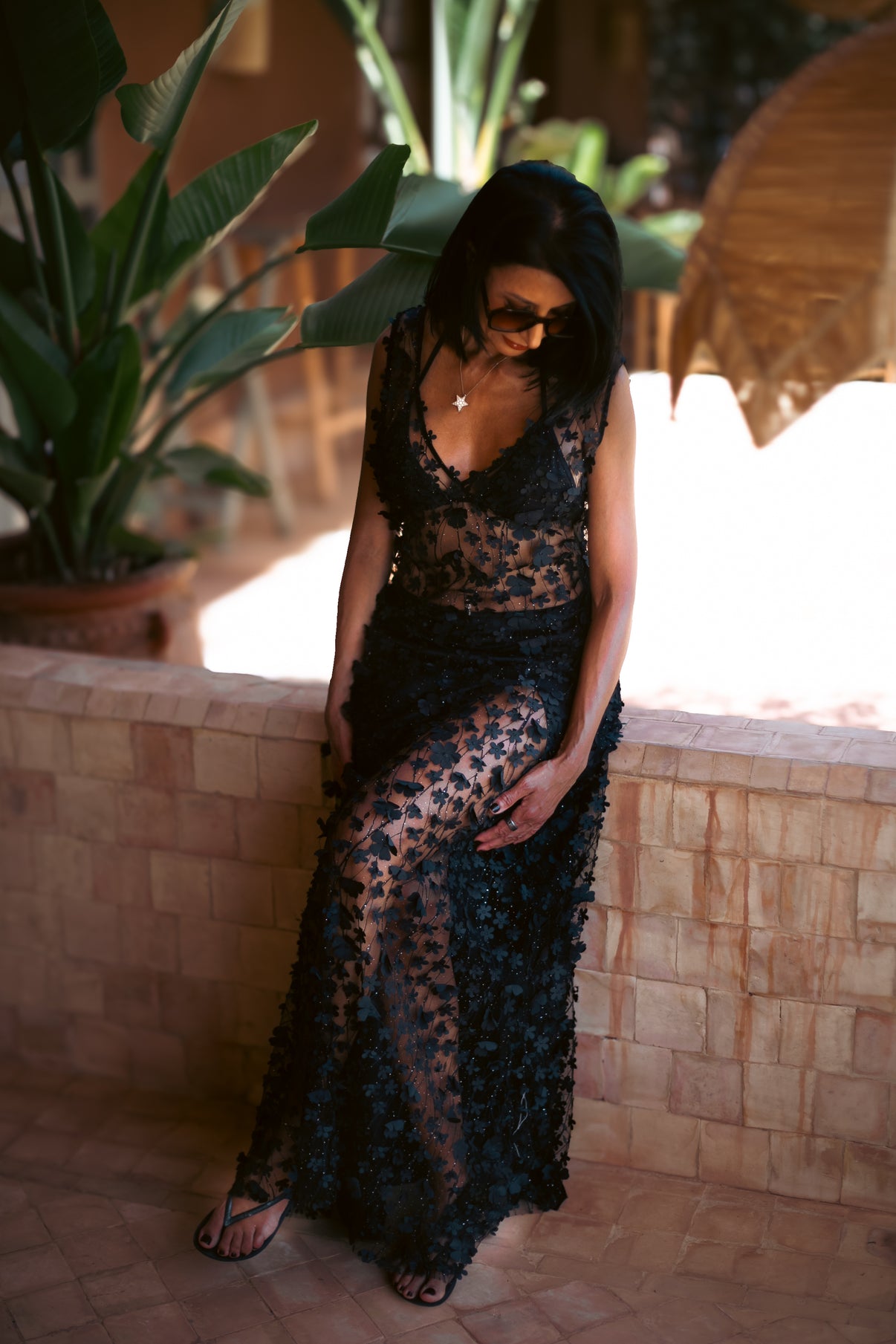 Daisy Noir gown styled with a black half slip, featuring intricate floral detailing and sheer texture