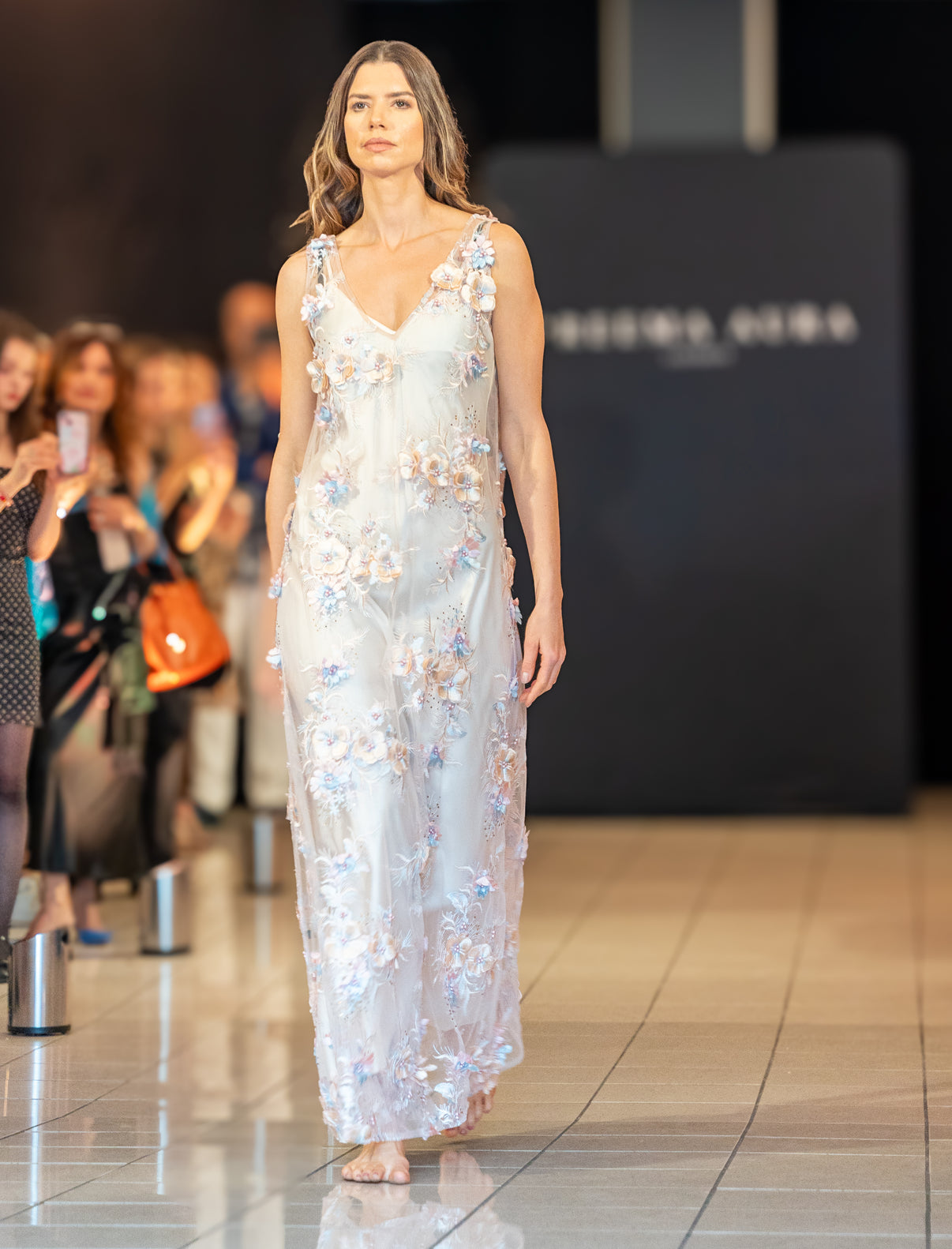 Model showcasing Petal Mist by Preema Aura over a cream slip, sheer white floral embroidered silk maxi dress, elegant runway style London.