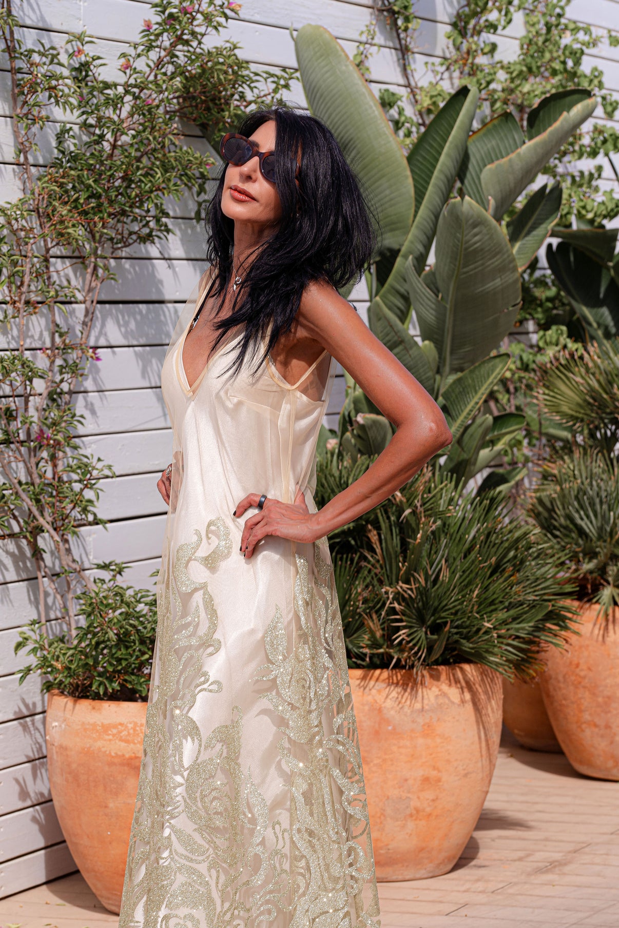 Model in the Citrine Essence dress, with a satin slip underneath, embracing slow living and sun-drenched style on the coast.