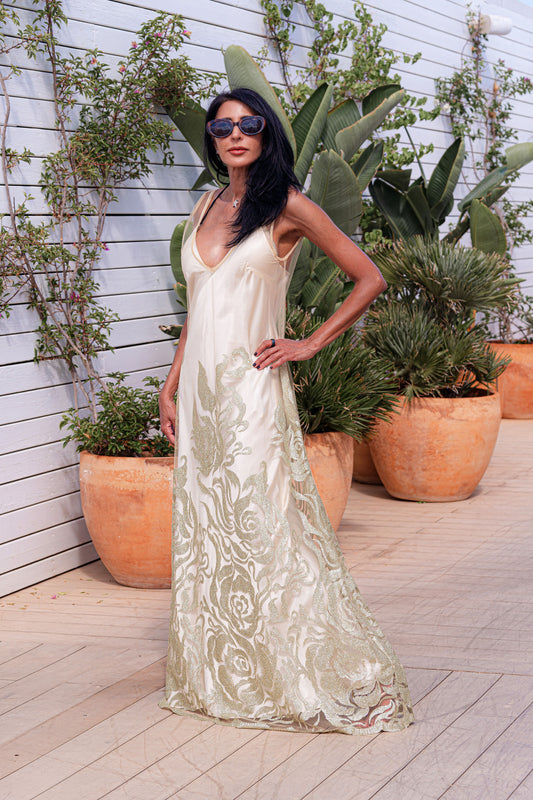 Preema Aura’s Citrine Essence dress with a cream satin slip underneath, featured in a dreamy poolside setting, ideal for warm-weather styling.