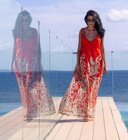 Elegant poolside fashion featuring the Enchanted Ember dress, styled for impact with a red satin slip underneath.