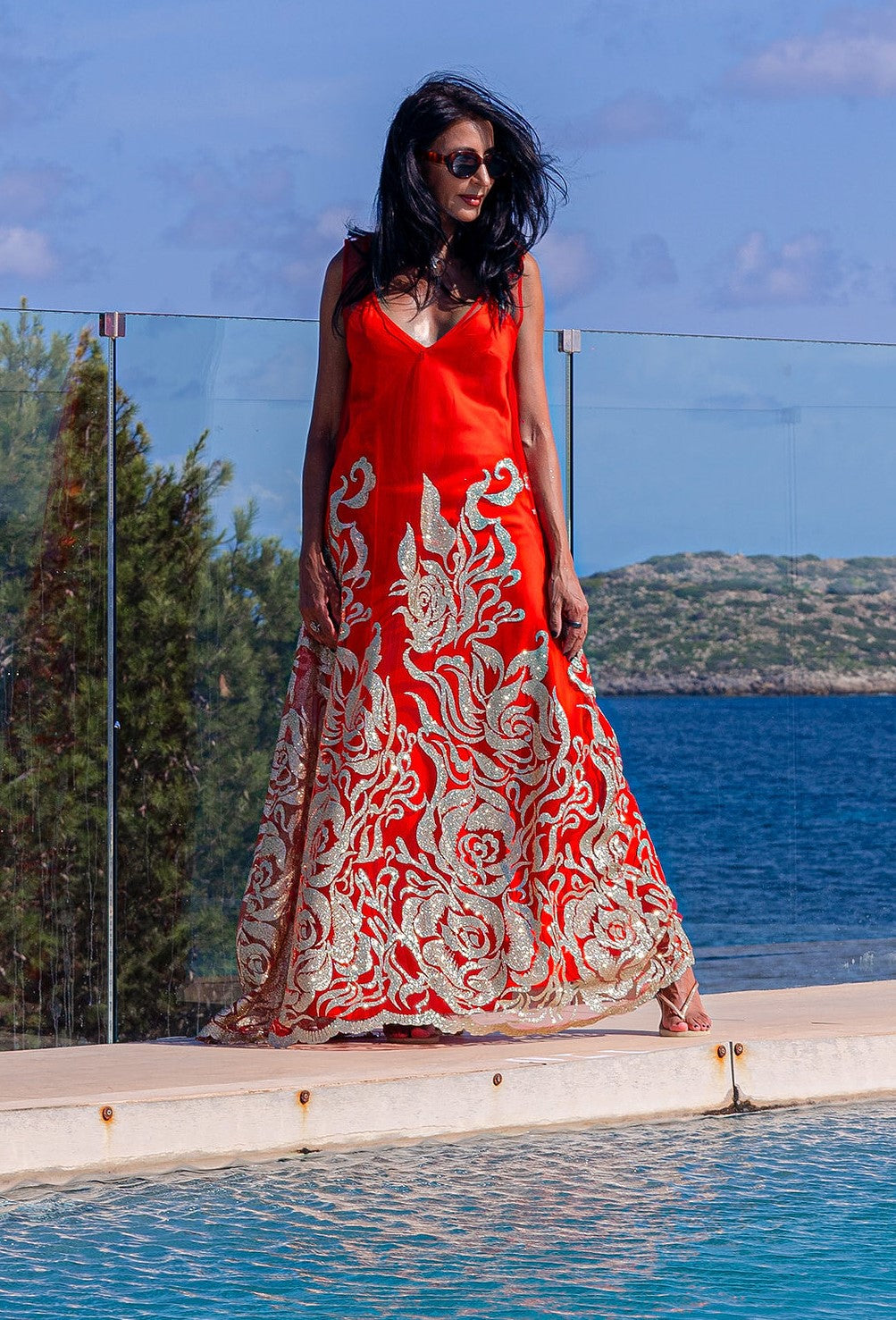Woman wearing the Enchanted Ember dress by Preema Aura, capturing warm tones and striking silhouette in a golden hour setting.