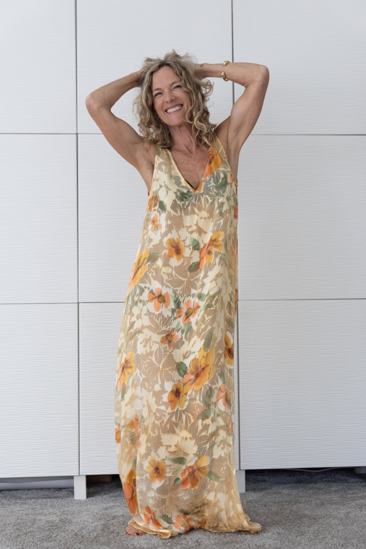 Soul Solstice French silk A-line slip dress styled over a bikini, showcasing its vivid red and amber print, light drape and radiant resortwear elegance.