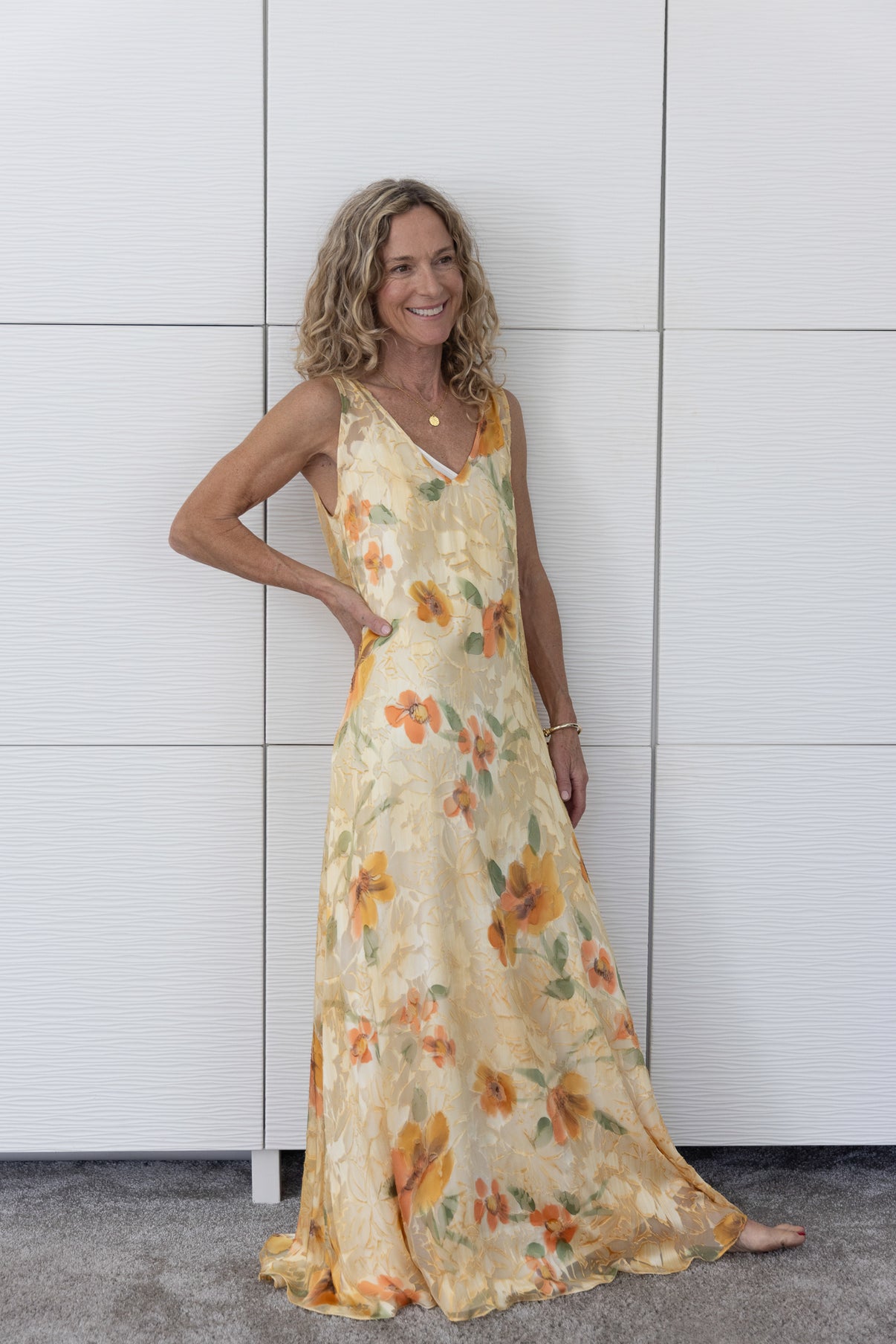 Soul Solstice French silk A-line slip dress styled over a cream slip, photographed indoors to emphasise its glowing sunset hues and effortless Preema Aura sophistication.