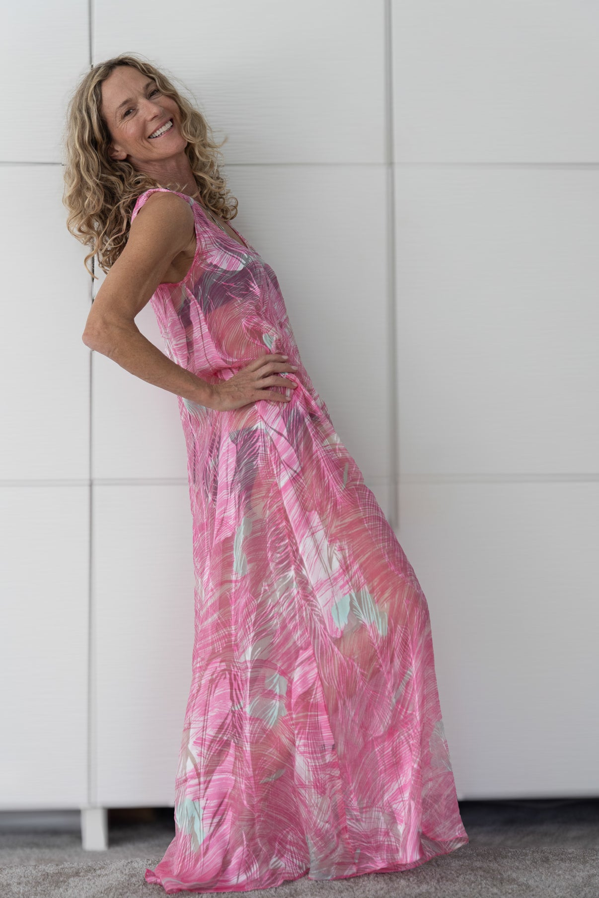 Back view of the Soul Wild French silk resortwear dress flowing over a bikini, showing the lightweight drape and movement of the fabric from Preema Aura’s Soul Series collection.