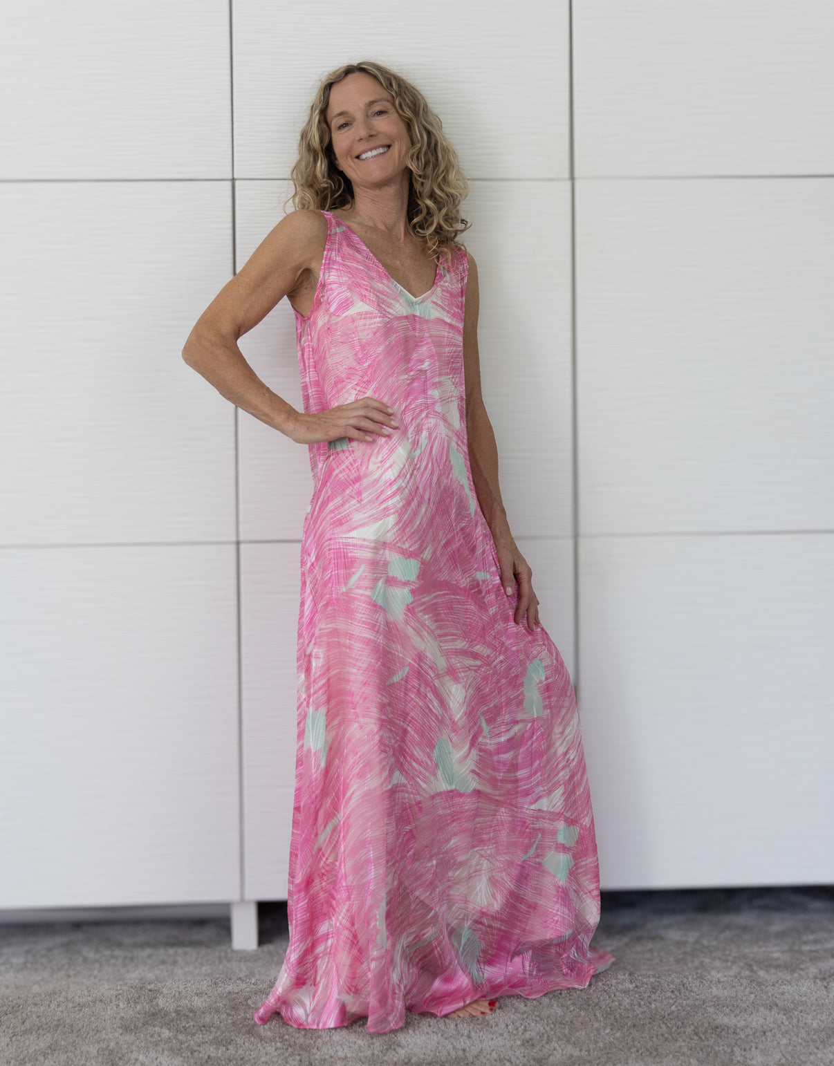 Detail shot of the Soul Wild French silk resortwear dress layered over a cream slip, emphasising the luxurious texture, fluid movement and abstract Soul Series print.