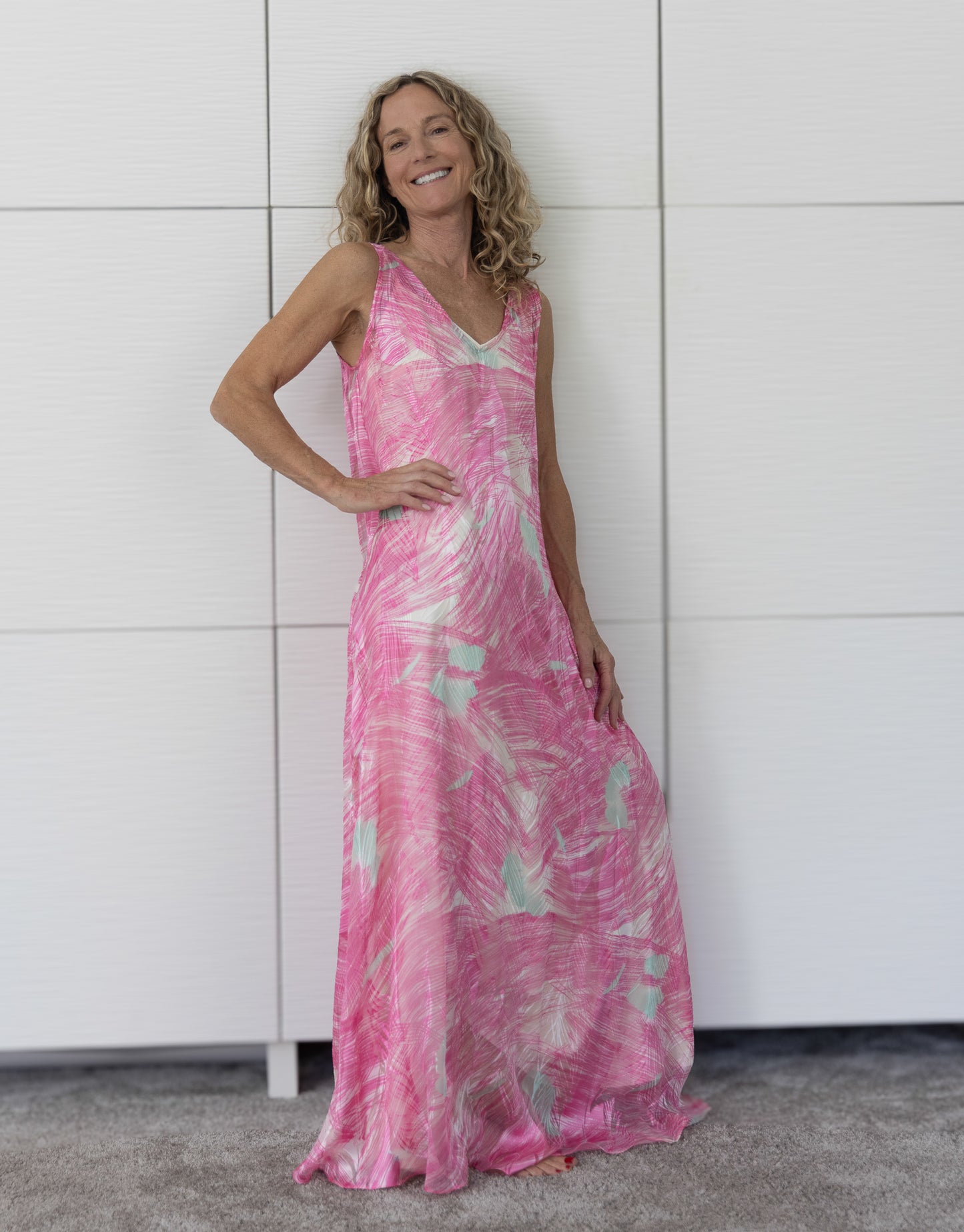 Detail shot of the Soul Wild French silk resortwear dress layered over a cream slip, emphasising the luxurious texture, fluid movement and abstract Soul Series print.