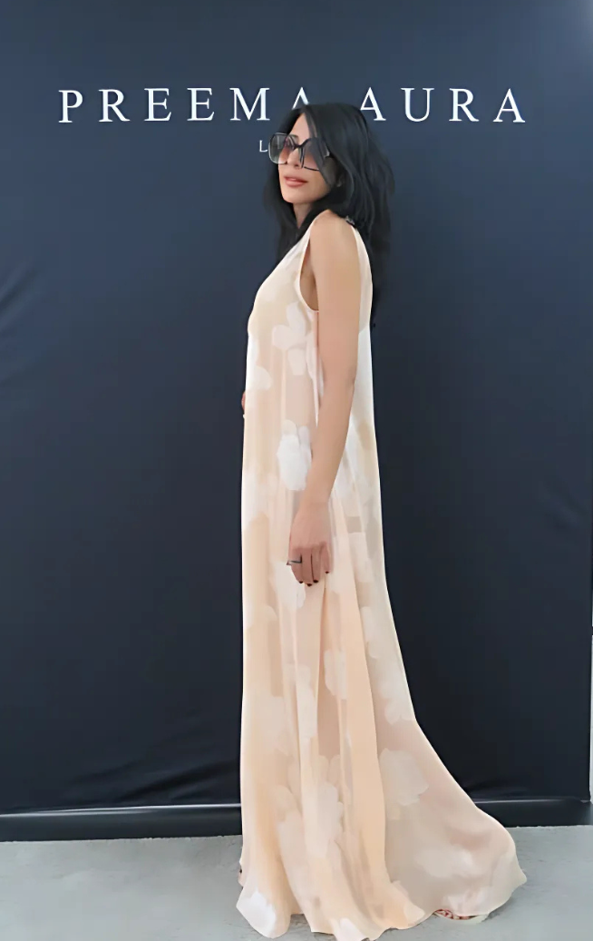 Side profile of model wearing Preema Aura Soul Series Bloom dress – sheer blush-toned silk gown with oversized ivory floral print and soft drape