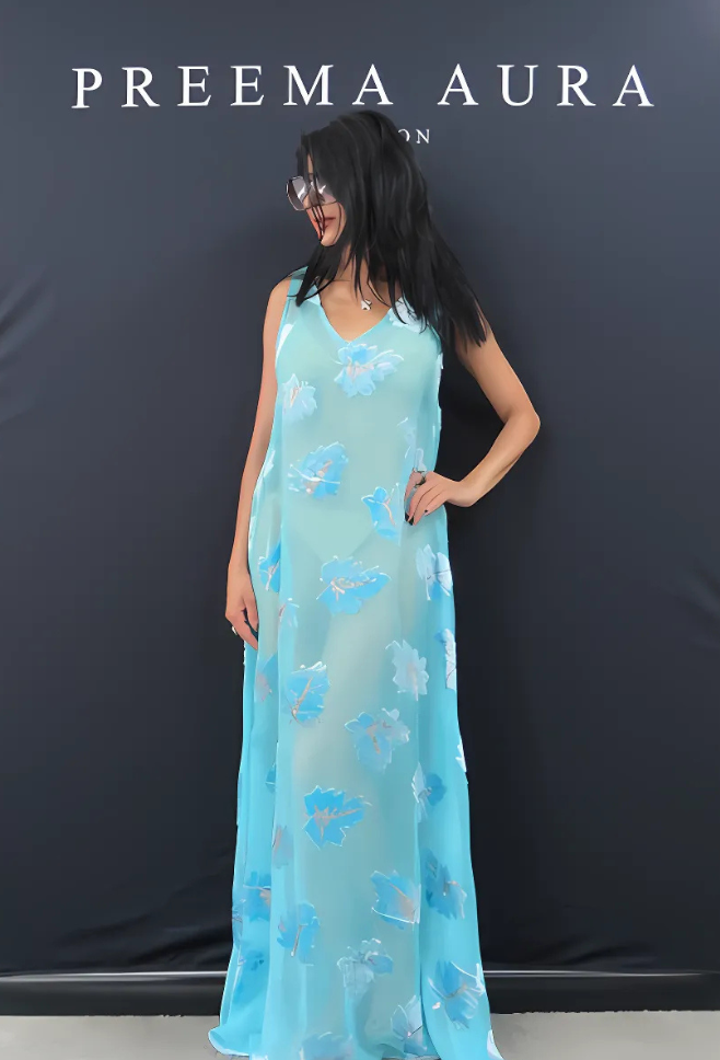 Model wearing Preema Aura Soul Series Cascade dress – sheer turquoise silk gown with floating blue and white floral print and fluid silhouette