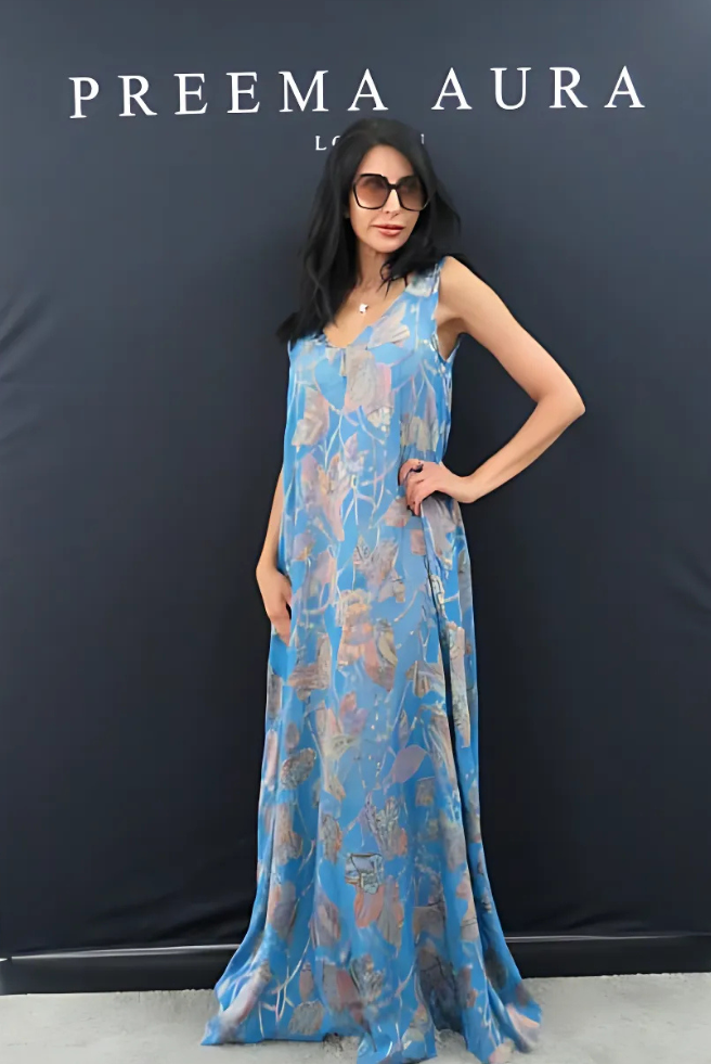 Model wearing Preema Aura Soul Series Drift dress – sheer blue silk gown with layered botanical print in soft rose, mauve, and sand tones