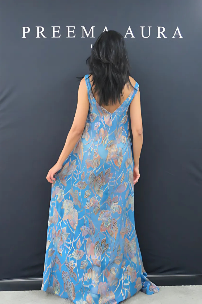 Back view of Preema Aura Soul Series Drift dress – translucent blue silk maxi dress with painterly foliage design and deep V-back.