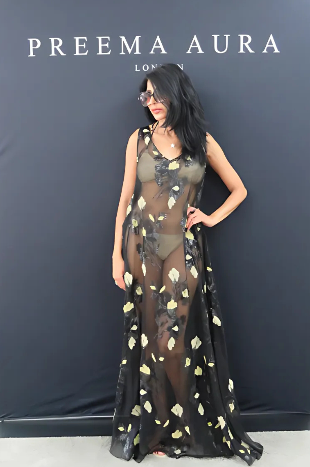 Model wearing sheer black silk Soul Eclipse gown with yellow embroidered floral detail, front view – Preema Aura luxury resortwear