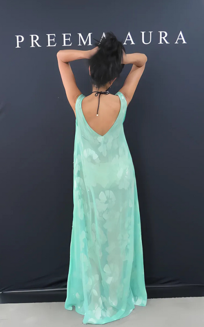Back view of model wearing Preema Aura Soul Eden silk dress in mint green with sheer floral embroidery and a deep V-back.