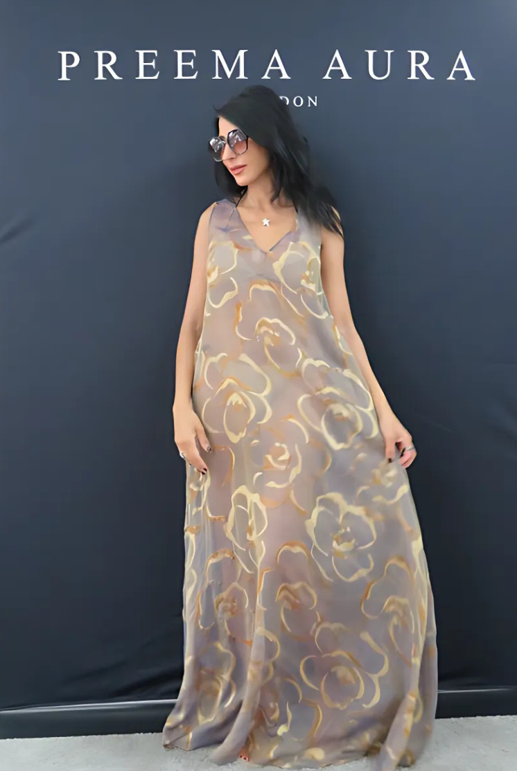 Model wearing Preema Aura Soul Series Ember dress – sheer silk maxi gown with warm amber and gold floral pattern on a smoky taupe base