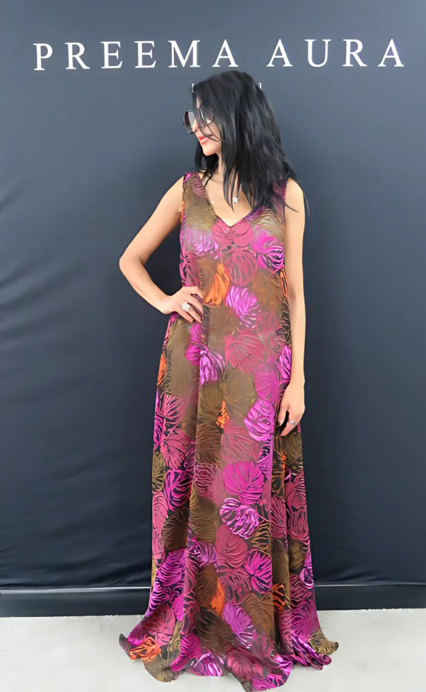 Model wearing the Soul Flame dress by Preema Aura – sheer silk gown in bold magenta, orange and earthy tones with oversized floral pattern and flattering V neckline.