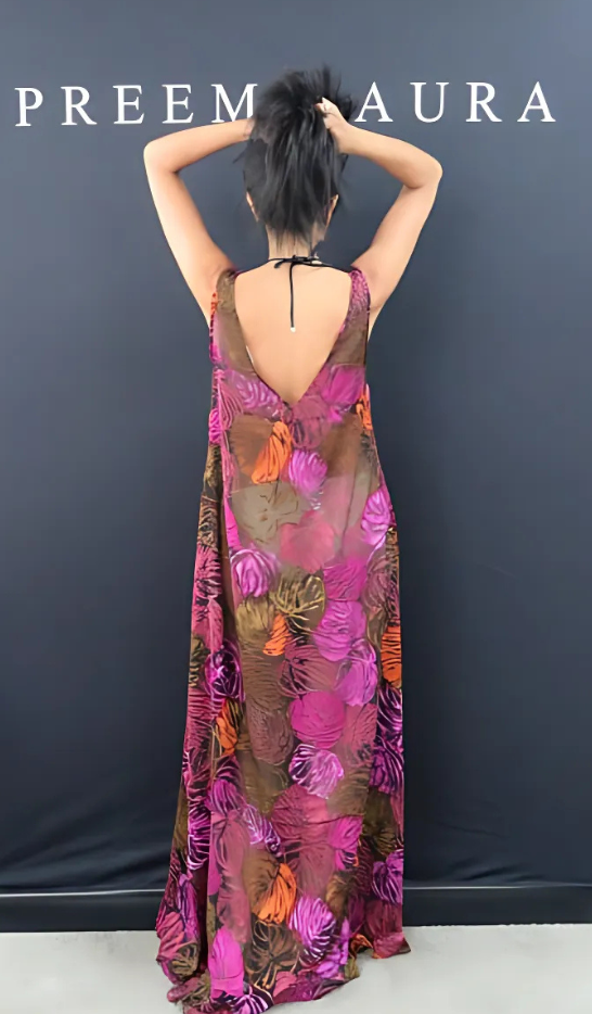 Back view of the Soul Flame dress – lightweight silk gown with open V back, showcasing vivid botanical pattern and flowing silhouette.