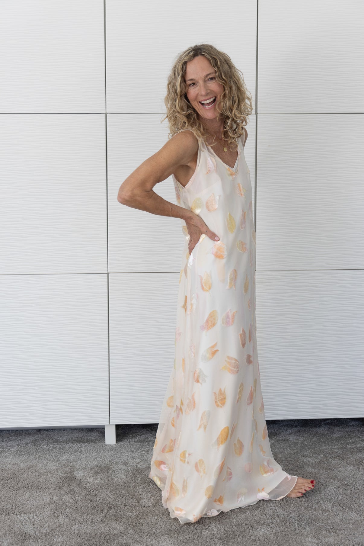 Soul Glimmer by Preema Aura worn over a cream slip — a feminine, longline sheer dress with shimmering pastel petal detailing, captured to show its light, flowing fabric and flattering movement.