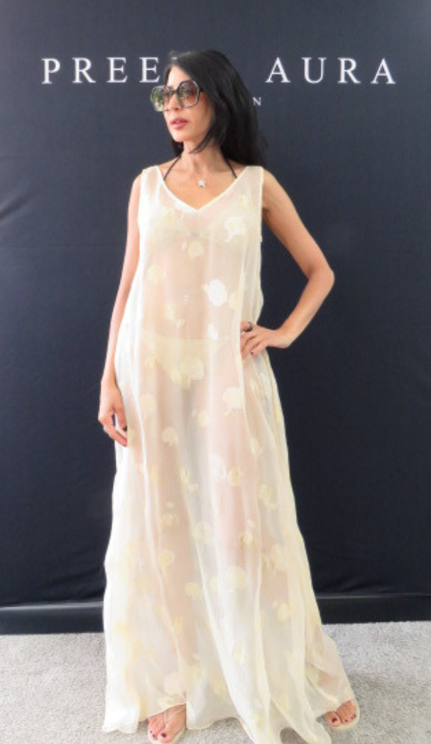 Model wearing Preema Aura Soul Series Lune dress – floor-length sheer ivory gown with soft yellow floral embroidery and fluid silhouette