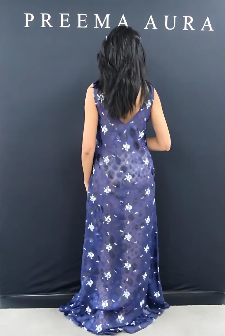 Back view of model wearing Preema Aura Soul Series Nightfall dress – sheer navy floral gown with elegant drape and floor-length silhouette