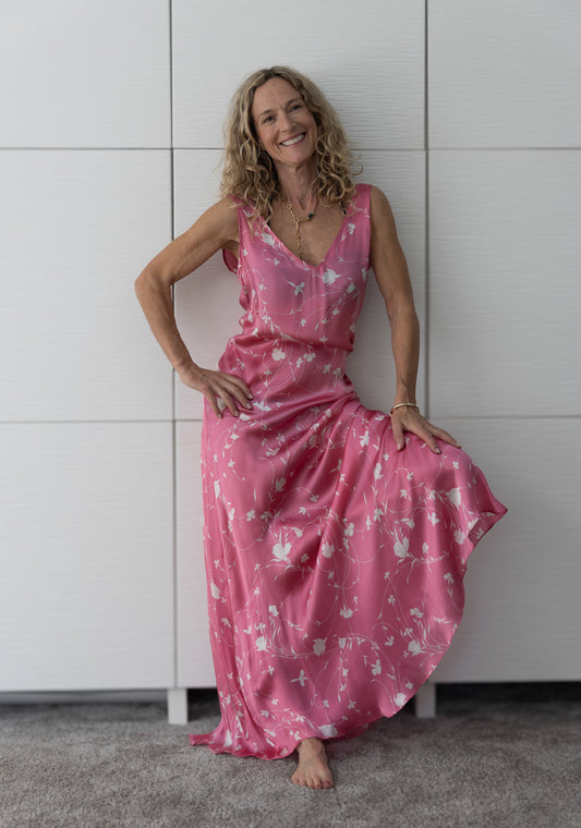 Soul Petal from the Preema Aura Soul Series – luminous pink maxi dress in fluid silk with soft white botanical detailing, capturing effortless movement and grace.