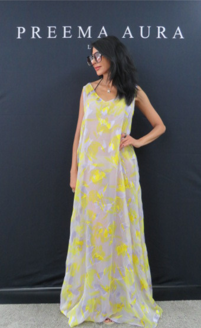 Model wearing Preema Aura Soul Series Radiance dress – sheer flowing maxi gown with bold yellow and lilac abstract floral design.