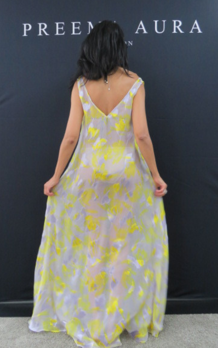 Back view of Preema Aura Soul Series Radiance dress – translucent pastel gown with yellow and purple floral print and elegant low V-back.