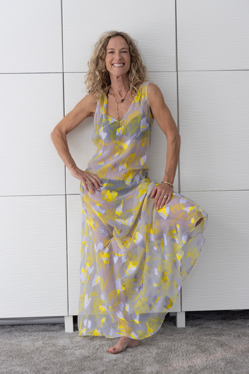 Model wearing the Preema Aura Soul Radiance dress — a lightweight, flowy floral maxi in soft lilac and sunshine yellow tones, photographed indoors in natural light