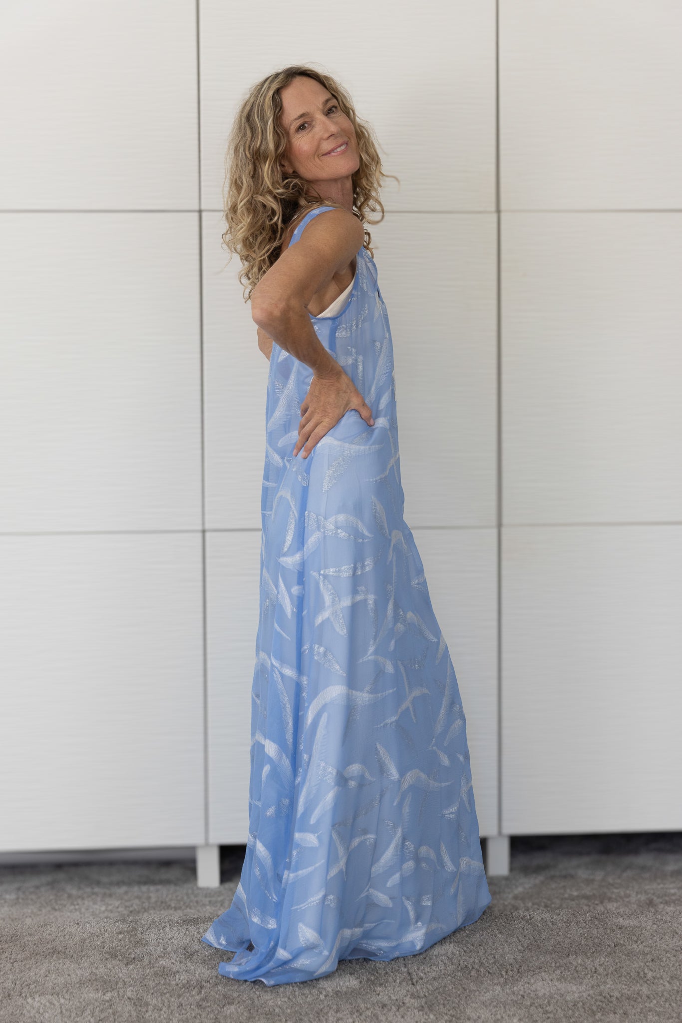 Soul Soar French silk A-line slip dress in sky-inspired tones of blue and white, layered over a cream slip and photographed indoors in natural light to capture its fluid, ethereal quality.