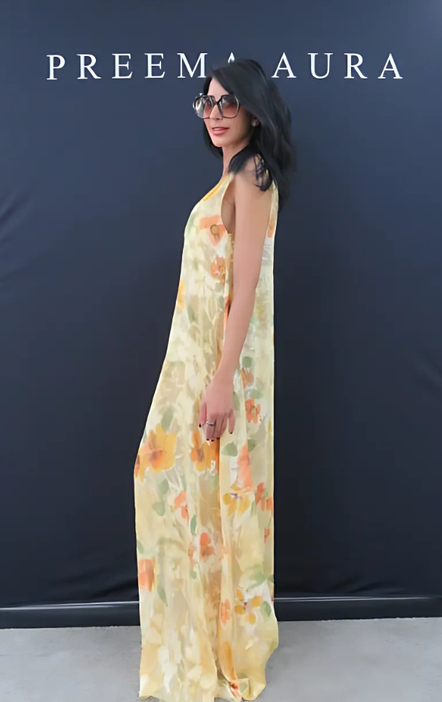 Side profile of model in Preema Aura Soul Series Solstice dress – long sheer silk gown with painterly orange florals and golden tones on a soft cream base