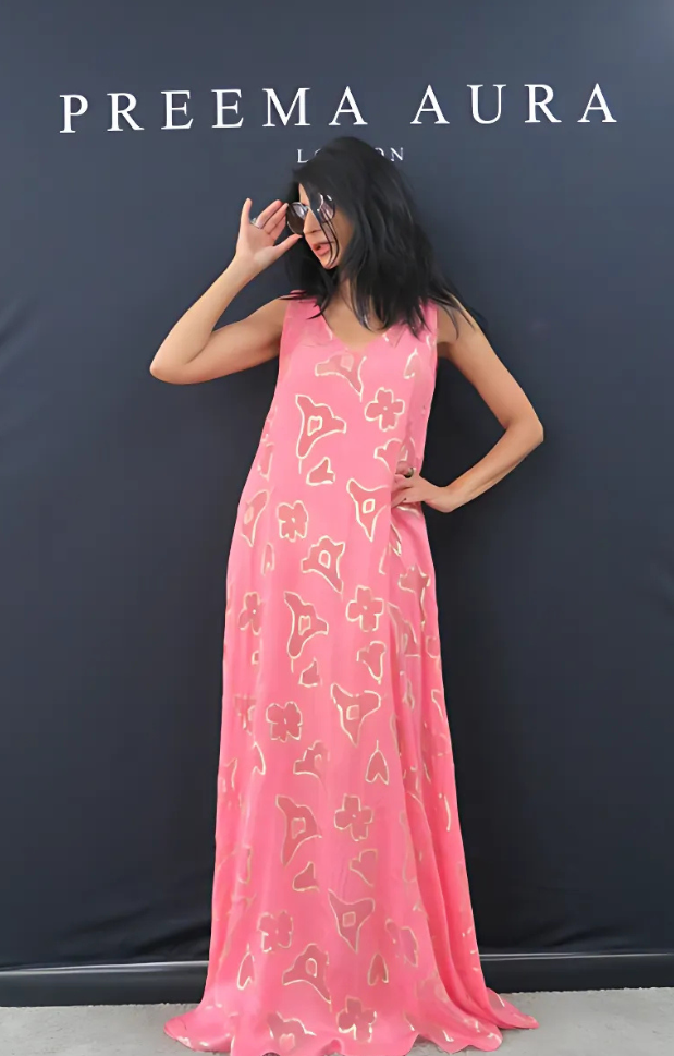 Model wearing Preema Aura Soul Series Spark dress – vibrant fuchsia silk gown with abstract gold floral motifs and a soft, flowing silhouette.