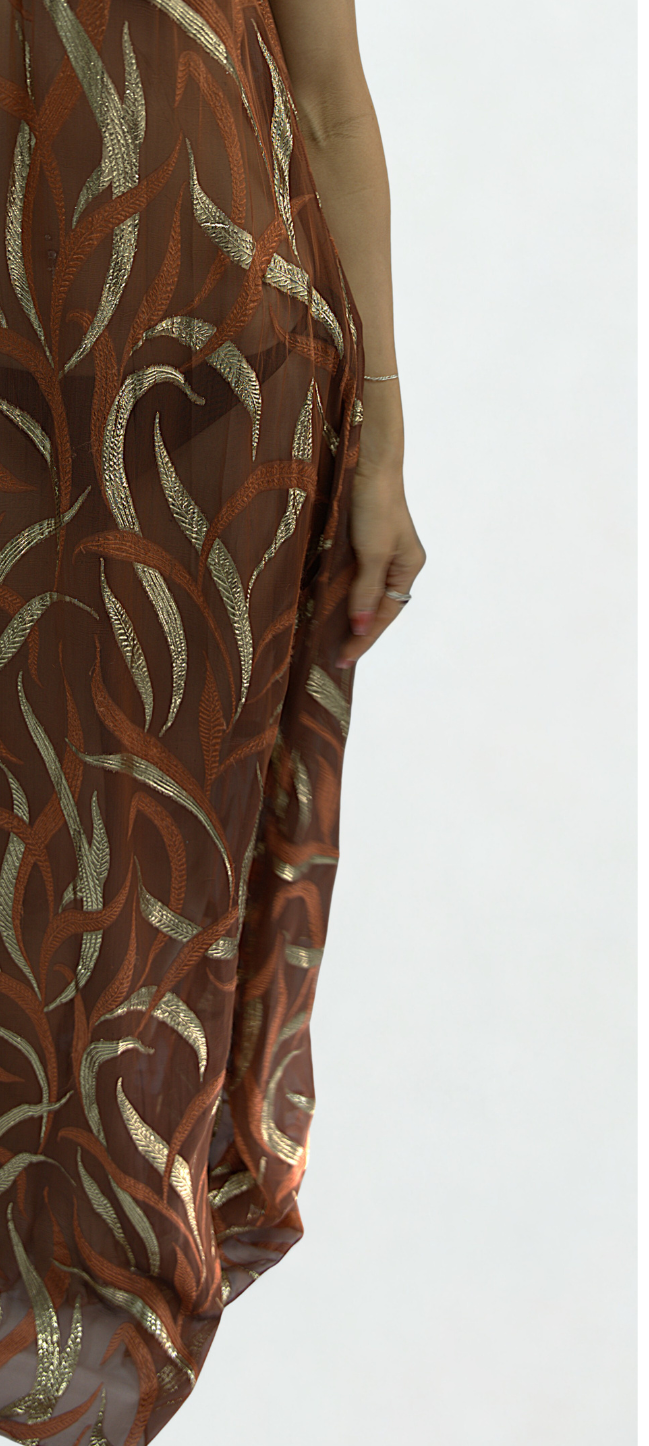 Close-up detail of the Soul Terra dress by Preema Aura, showcasing copper silk with gold embroidered abstract botanical pattern