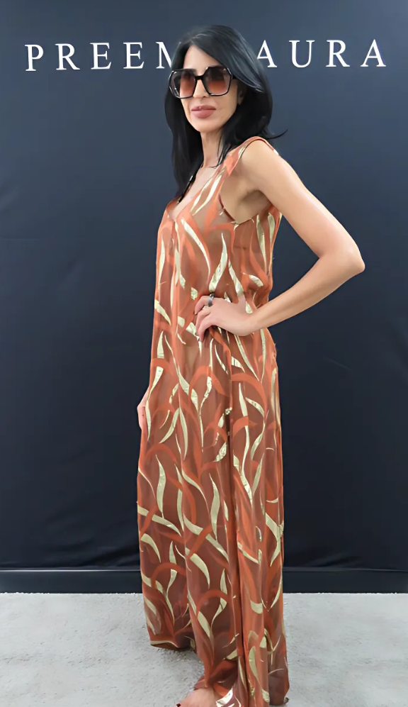 Side profile of model in the Soul Terra silk gown by Preema Aura, highlighting the flowing silhouette and metallic embroidery