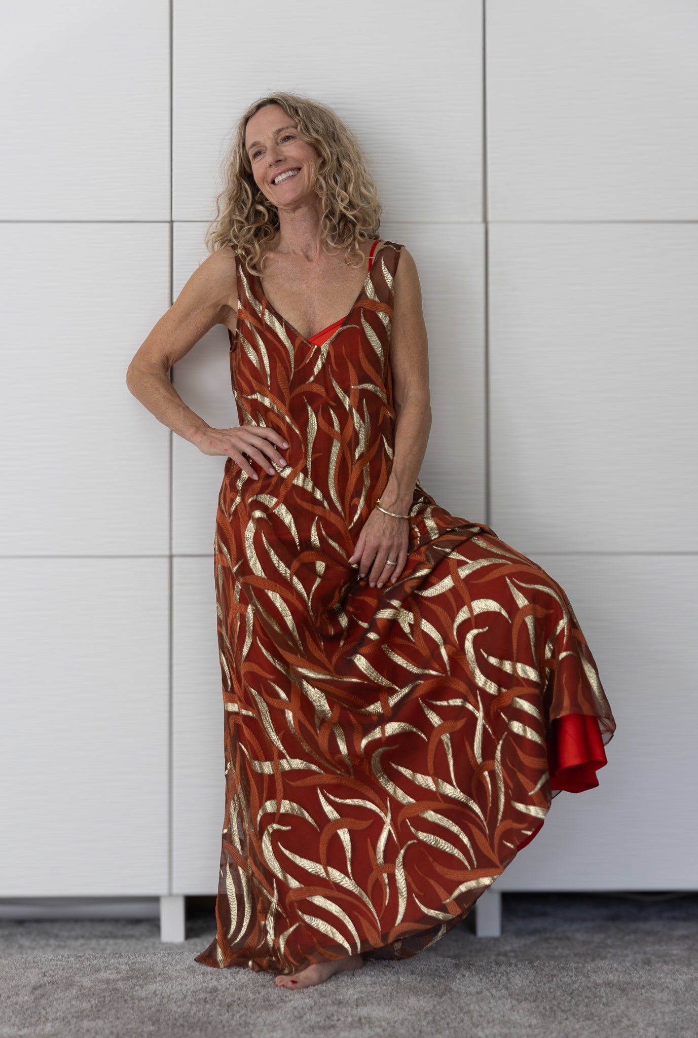 Soul Terra by Preema Aura – bronze-and-gold sheer dress paired with a bold red slip, evoking confidence and energy within the limited-edition Soul Series collection.