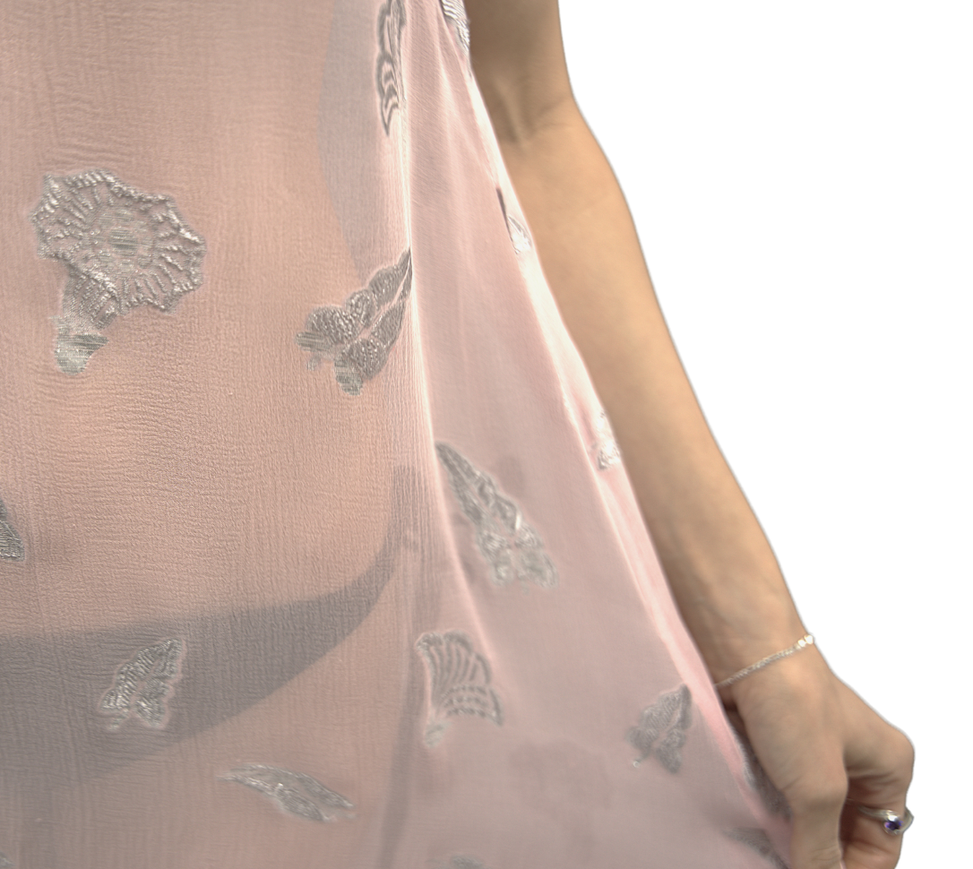 Close-up of the sheer silk fabric of the Soul Whisper dress, showcasing delicate silver embroidery and soft pink tones.