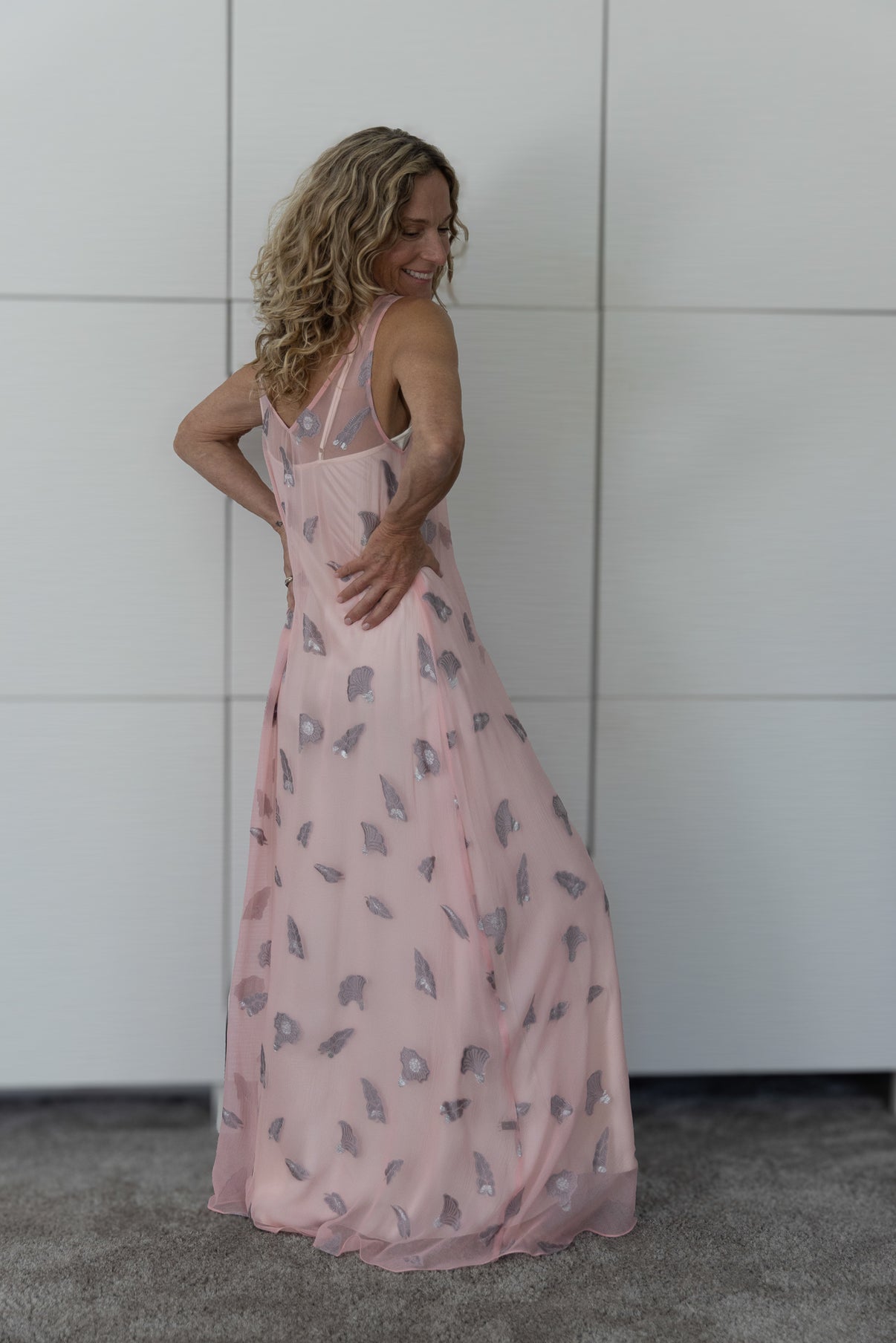 Rear view of the Soul Whisper French silk A-line slip dress worn over a cream slip, highlighting its delicate brushstroke print, fluid texture and understated Preema Aura elegance.