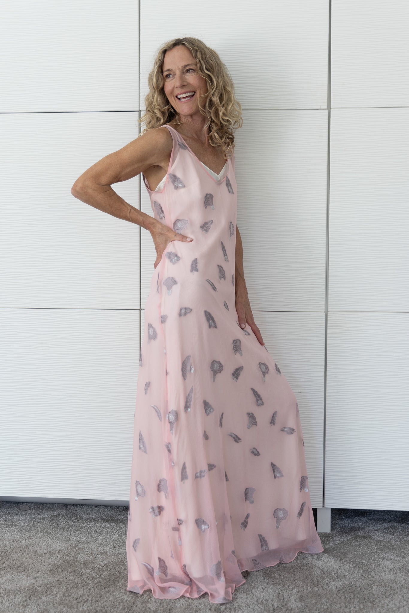 Soul Whisper French silk A-line slip dress in soft neutral tones, layered over a cream slip and photographed indoors in natural light to reveal its airy movement and subtle sheen.