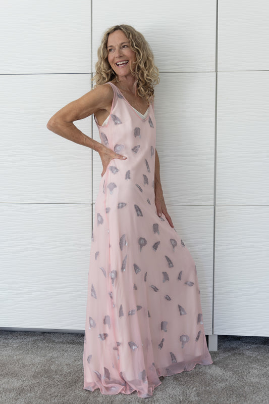 Soul Whisper French silk A-line slip dress in soft neutral tones, layered over a cream slip and photographed indoors in natural light to reveal its airy movement and subtle sheen.