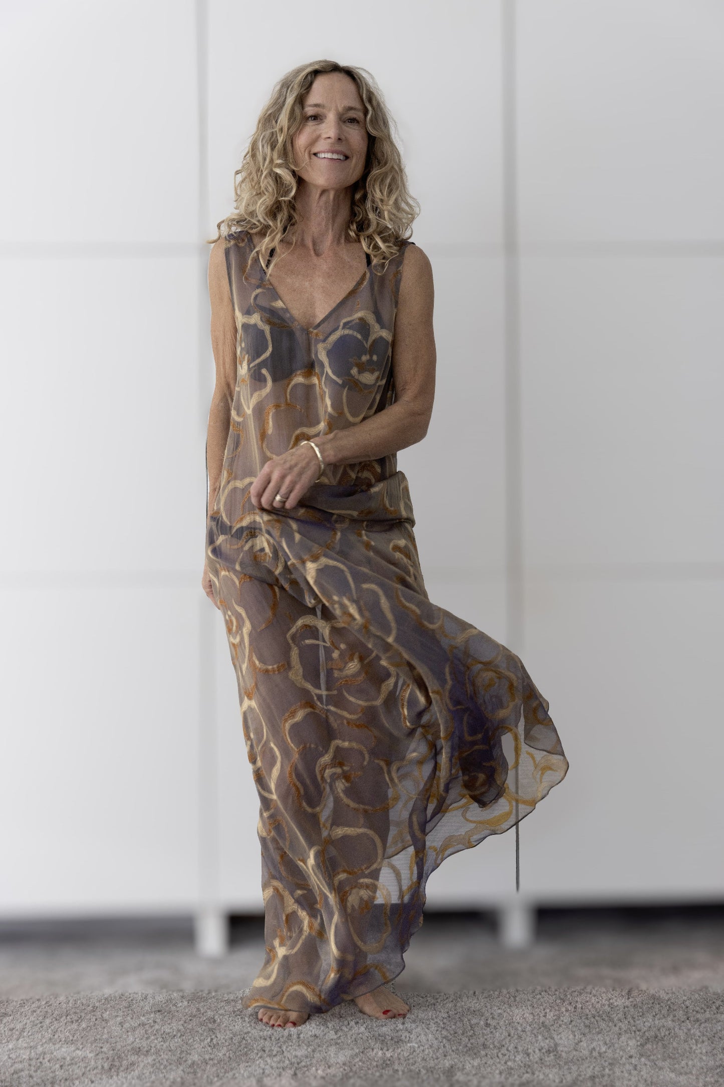 Model in the Preema Aura Soul Ember brown and gold sheer silk maxi dress, showcasing its flowing silhouette and natural movement.