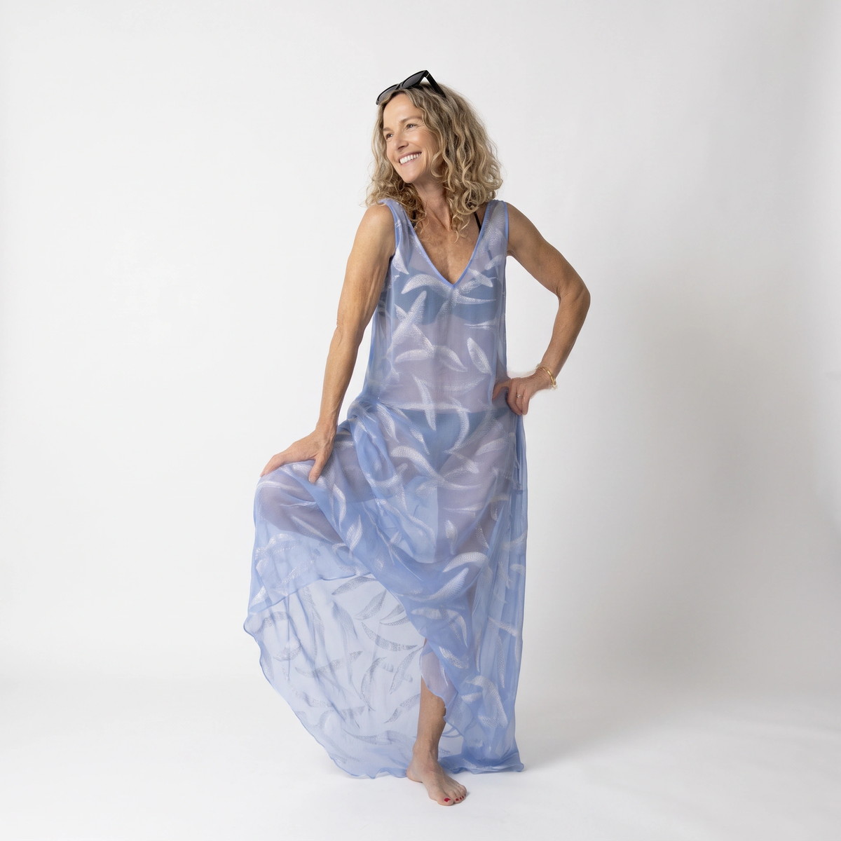 Woman modelling the Preema Aura Soul Soar sheer blue maxi dress over a bikini, showing the flowing fabric