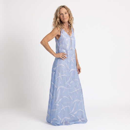Full-length front view of the Preema Aura Soul Soar sheer blue maxi dress over a cream satin slip