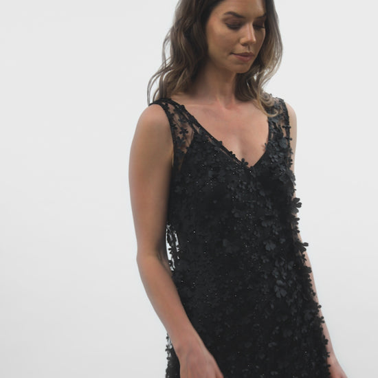 Video showcasing the movement of the Daisy Noir dress with a black satin slip underneath