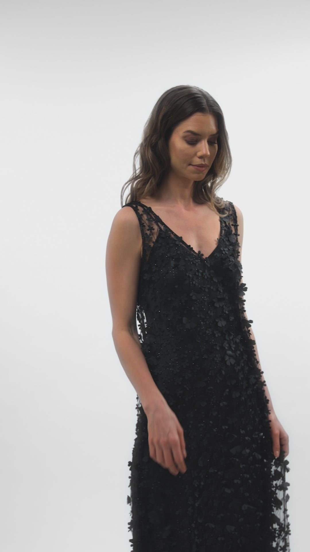 Video showcasing the movement of the Daisy Noir dress with a black satin slip underneath